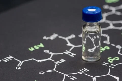 Close-up blue cap sample vial on paper with chemical formula of Oxytocin (l.. Stock Photos