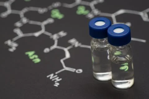 Close-up blue cap sample vial on paper with chemical formula of Oxytocin (l.. Stock Photos