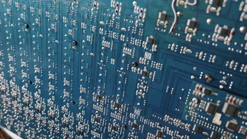 Close Up of a Blue Circuit Board with Intricate Electronic Components Stock Footage 334114806