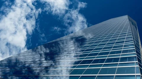 A close up of a blue cloud slow motion with a huge skyscraper Stock Footage 141150270