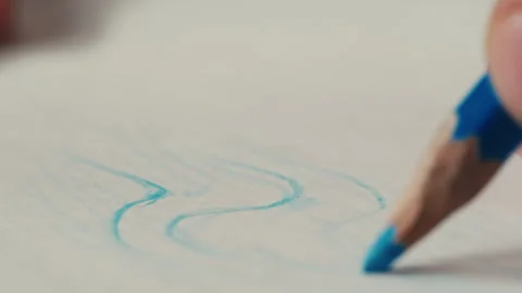 Close-up of blue colour pencil drawing on white paper macro. The designer making Stock-Footage 274742381