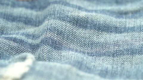 Close up of blue denim fabric texture with soft folds and weave pattern Stock Footage 331695081