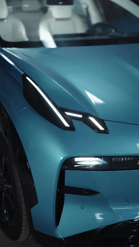 Close-up of blue electric SUV front with modern LED headlights Vídeos de archivo 318417665