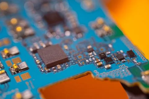 Close up of blue electronic circuit board with microchip, soldered componen.. Stock Photos