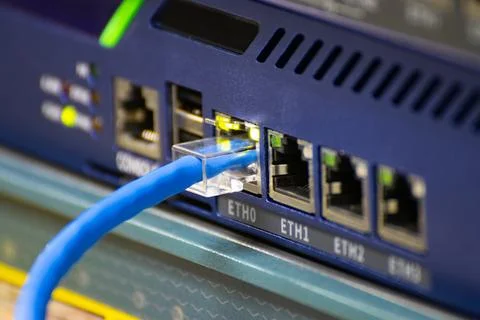 Close-up a blue ethernet cable into a network switch or router. Concept of .. Stock-Fotos
