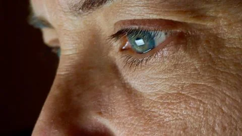 Close up blue eye in front of a pc screen images Stock Photos