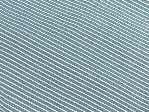 Close-up of blue fabric with diagonal white stripes. Stock Photos