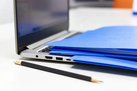 Close Up Blue file folder and Laptop Computer on desk in meeting room Stock Photos