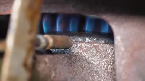 Close-up of Blue Gas Burner Flames on Rusty Outdoor Grill Stock Footage 338211157