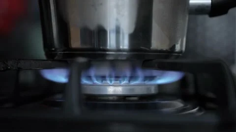 Close-up of Blue Gas Flame Burning on Kitchen Stove with Pan Stock Footage 301424726