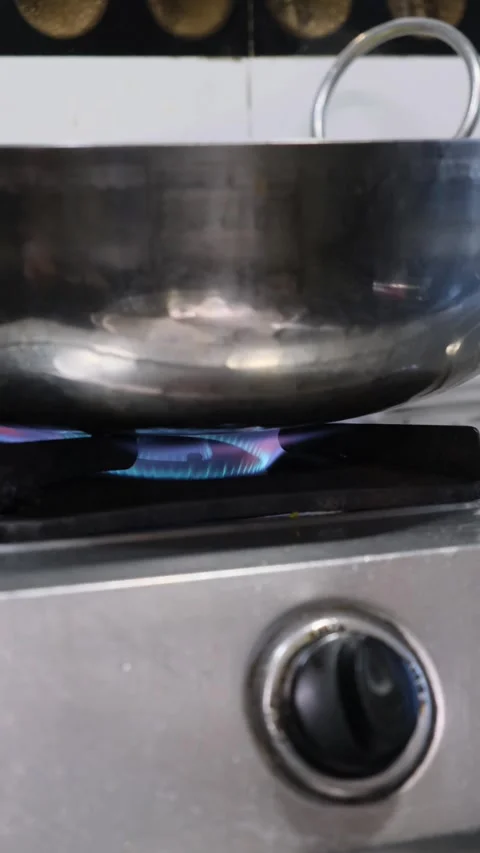 Close up of blue gas flame burning on kitchen stove under steel cooking pan 스톡 동영상 331898834