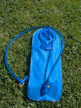 Close-up of blue hydration bladder with hose highlights practical water Stock Photos
