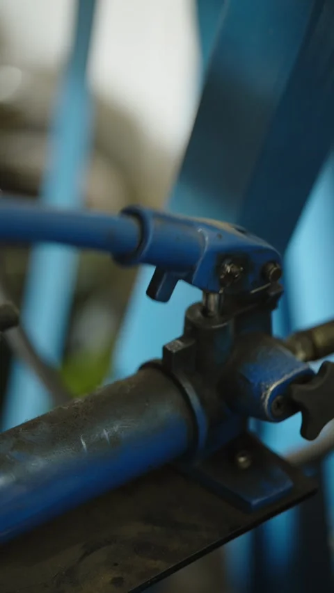 Close-up of a blue hydraulic hand pump in workshop Stock Footage 337567601