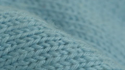 Close-up of blue knitted jumper surface 4K video Stock Footage 194668594