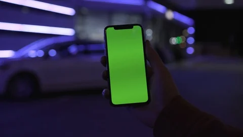 Close up blue light young man hands holding use smartphone with vertical green Stock Footage 111603877