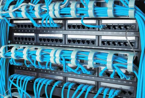 Close up of blue network internet cables connected to router Stock Photos