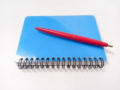 Close Up Blue Note Book or Diary book with red Pen on isolated white backgrou Stock Photos