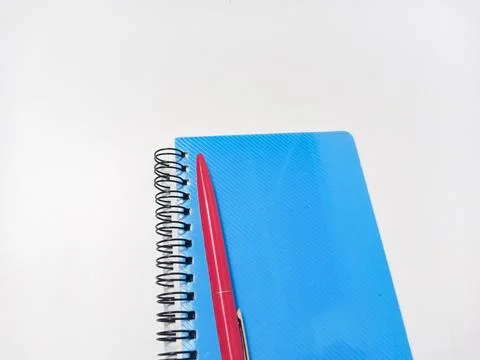 Close Up Blue Note Book or Diary book with red Pen on isolated white backgrou Stock Photos