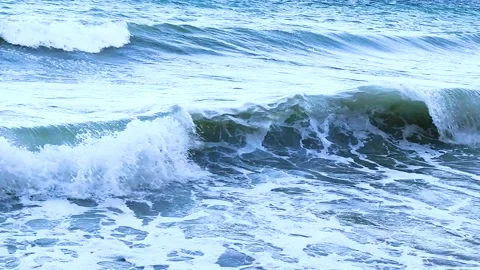 Close Up of Blue Ocean Waves Crashing on the Shore with White Sea Foam Video stock 332251508
