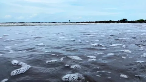 Close-up of blue Ocean Waves on a Sandy Beach with blue sky.  4K Stock Footage 301449848