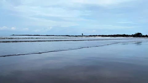 Close-up of blue Ocean Waves on a Sandy Beach with blue sky.  4K Video stock 301449850