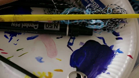 Close Up Of Blue Paint And Other Art Supplies On A Plate Stock Footage 221876995