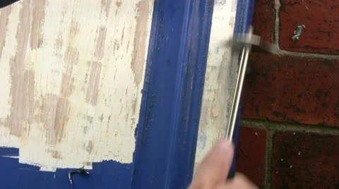 Close up of blue paint being removed from a kitchen cupboard door Stock Footage 26225427