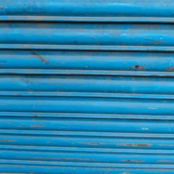 A close-up of a blue painted metal roller shutter Stock Photos