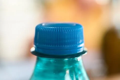 Close-up of a blue plastic bottle cap on a sparkling water bottle Stock Photos