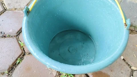 A close-up of a blue plastic bucket showing water droplets Stock Footage 304049849