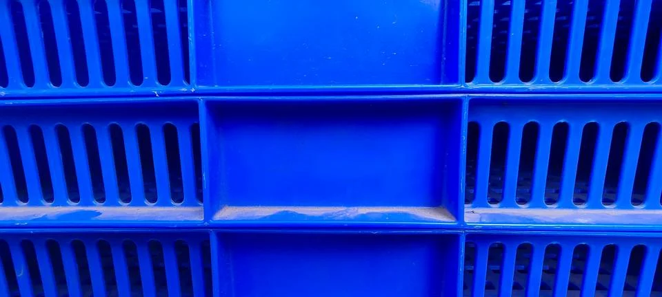 Close Up of Blue Plastic Crate with Grid Like Design and Slits Stock Photos