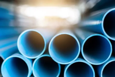 Close up to blue plastic pipe background, PVC pipes stacked in warehouse, Stockfoto's
