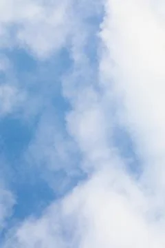 Close-up blue sky background with soft clouds. blue texture of cloudy sky. Stock Photos