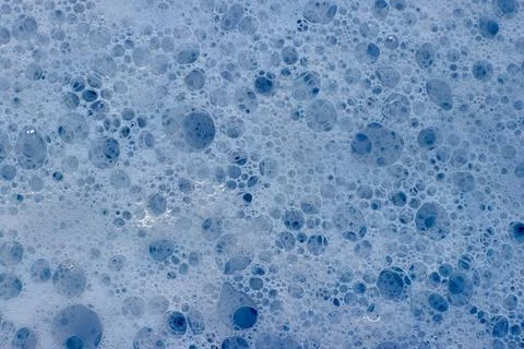 Close-up of blue-tinted soapy foam. Background for design Stock Photos