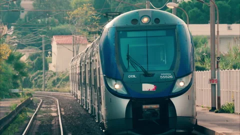 Close up of a blue train moving on the rails in France Stock Footage 295653915