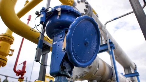 Close-up of blue valve on yellow pipe Stock Footage 127367986