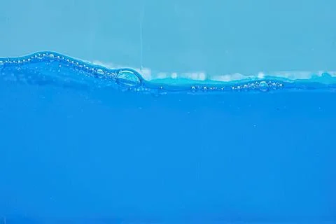 Close-up of blue water with bubbles and ripples Stock Photos
