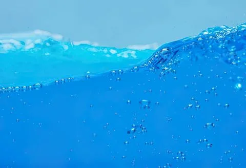 Close-up of blue water with bubbles and waves Stock Photos