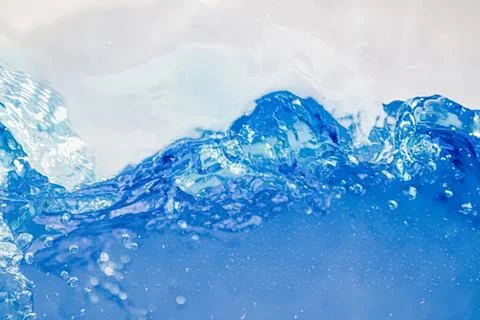Close-up of blue water splash with bubbles and waves Stock Photos