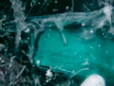 Close up of a blue water surface with bubbles emerging Stock Photos