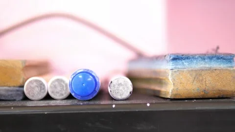Close-up of blue whiteboard marker and erasers on blackboard shelf for education Stock Footage 329355065