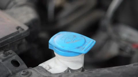 Close-up of a blue windshield washer fluid reservoir cap. Stock Footage 345709216