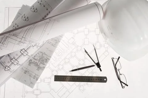 Close-up of blueprints with sketches of projects, eyeglasses, helmet and some me Stock Photos