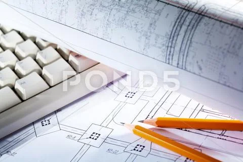 Close-up of blueprints with sketches of projects, pencils and computer keypad Stock Photos