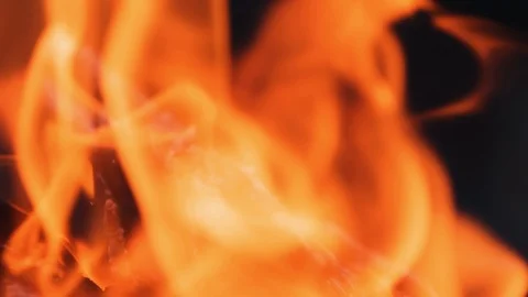 Close-up blur bright flame. Vivid flame of bonfire on dark background.  Stock Footage 121707180