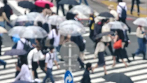 Close up blur Pan slow motion of pedestrian holding umbrella in rain Stock-Footage 196077066