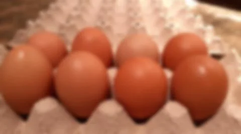 Close-up blurred background of brown box raw chicken eggs concept. Stock Photos