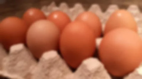 Close-up blurred background of brown box raw chicken eggs concept. Stock Photos