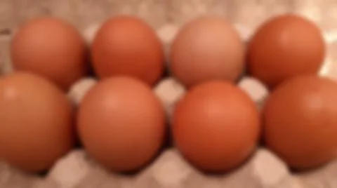 Close-up blurred background of brown box raw chicken eggs concept. Stock Photos