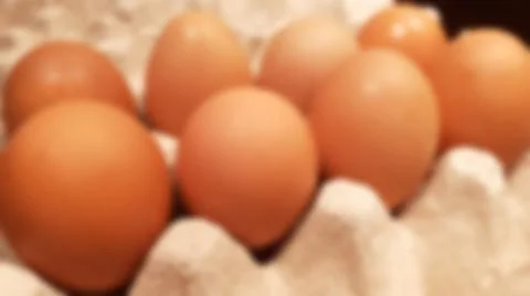 Close-up blurred background of brown box raw chicken eggs. Stock Photos